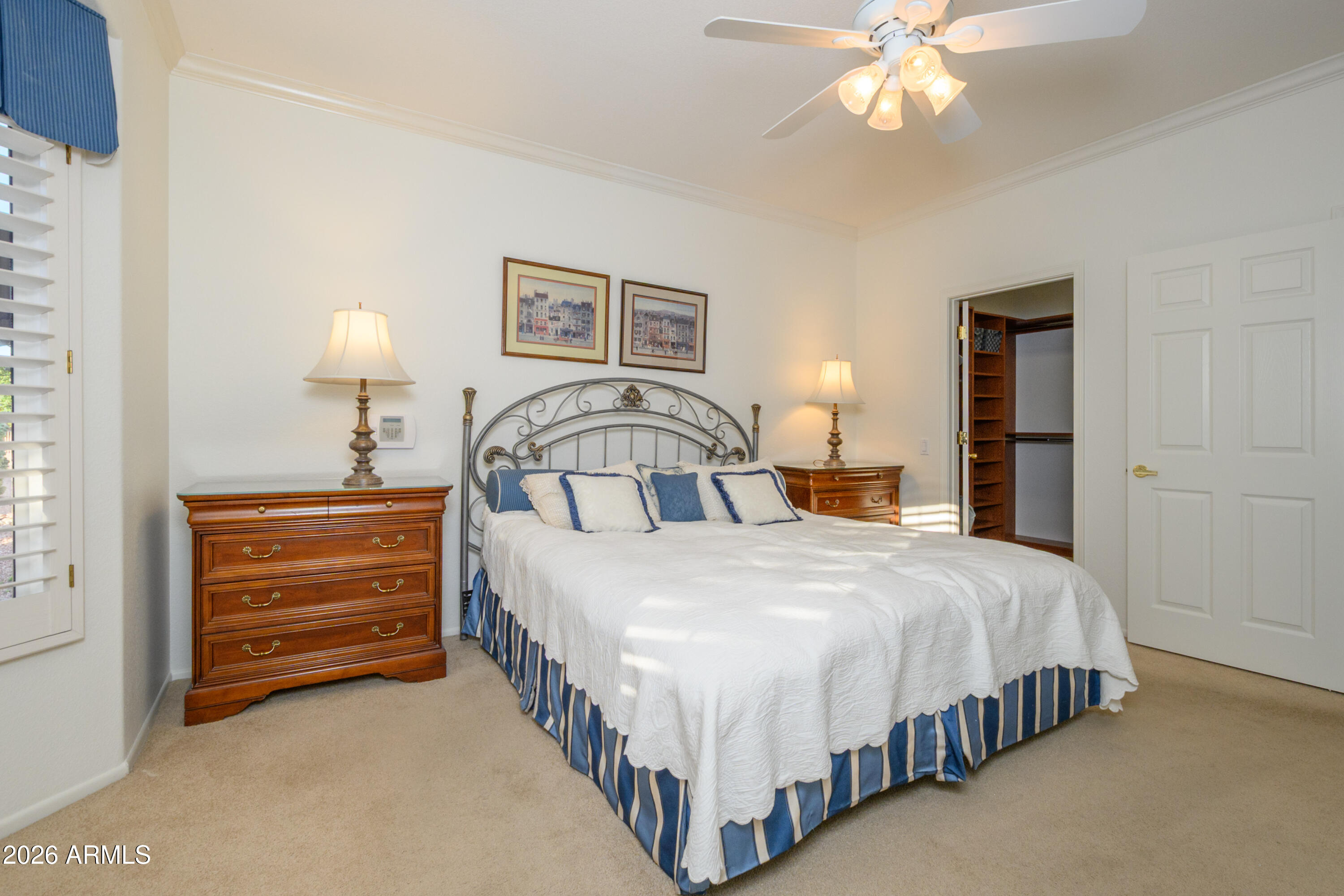 15883 West Cisa Rio Lane Surprise, AZ 85374 - Photo 28 of 45 a bedroom with a bed and a chandelier