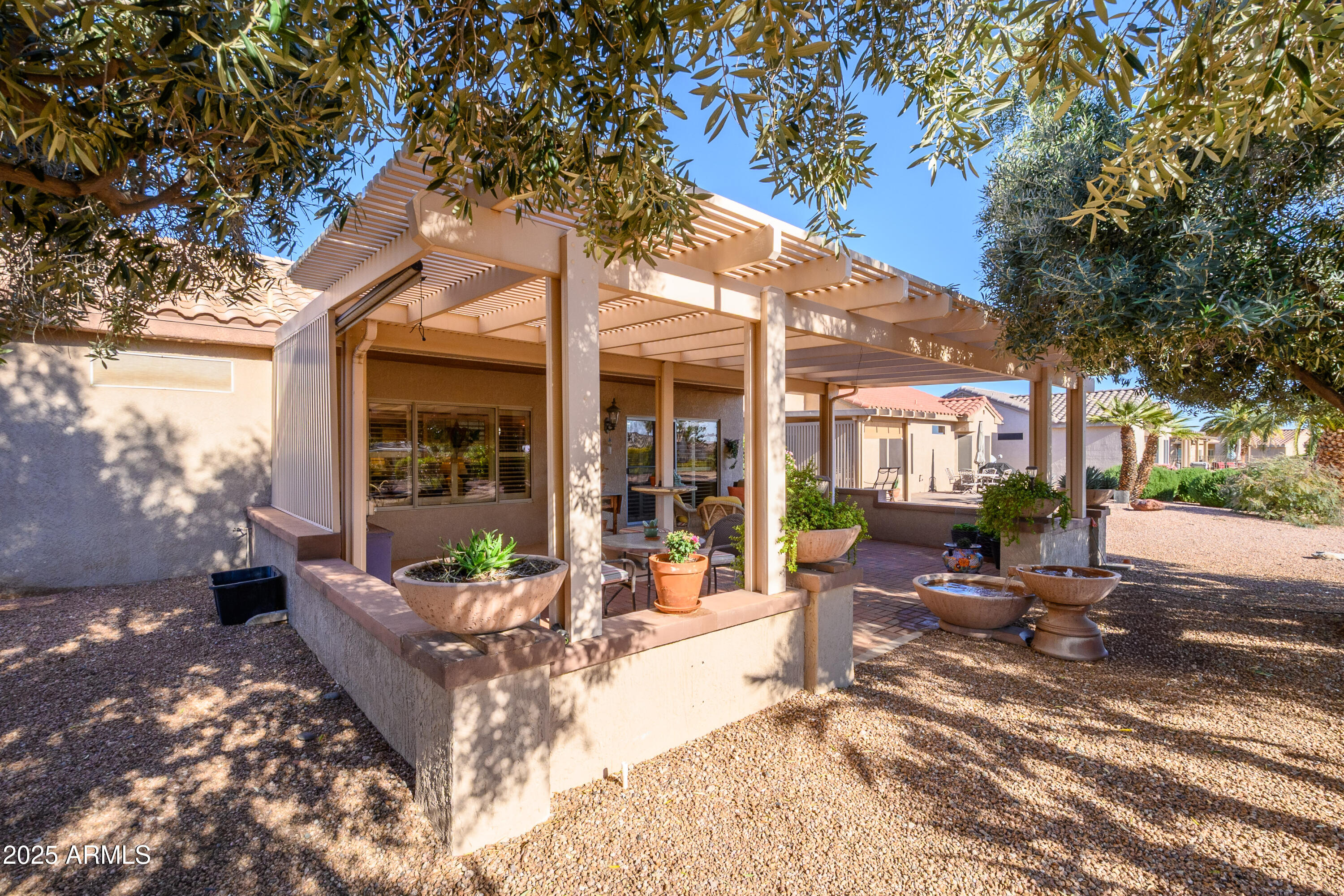 15883 West Cisa Rio Lane Surprise, AZ 85374 - Photo 41 of 45 a view of a house with backyard sitting area and porch
