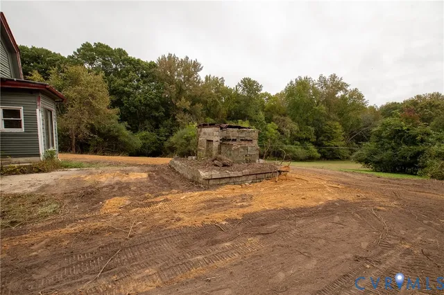 a view of a yard with trees in front of it