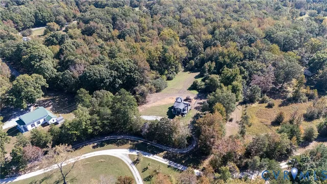 an aerial view of house with yard and outdoor seating