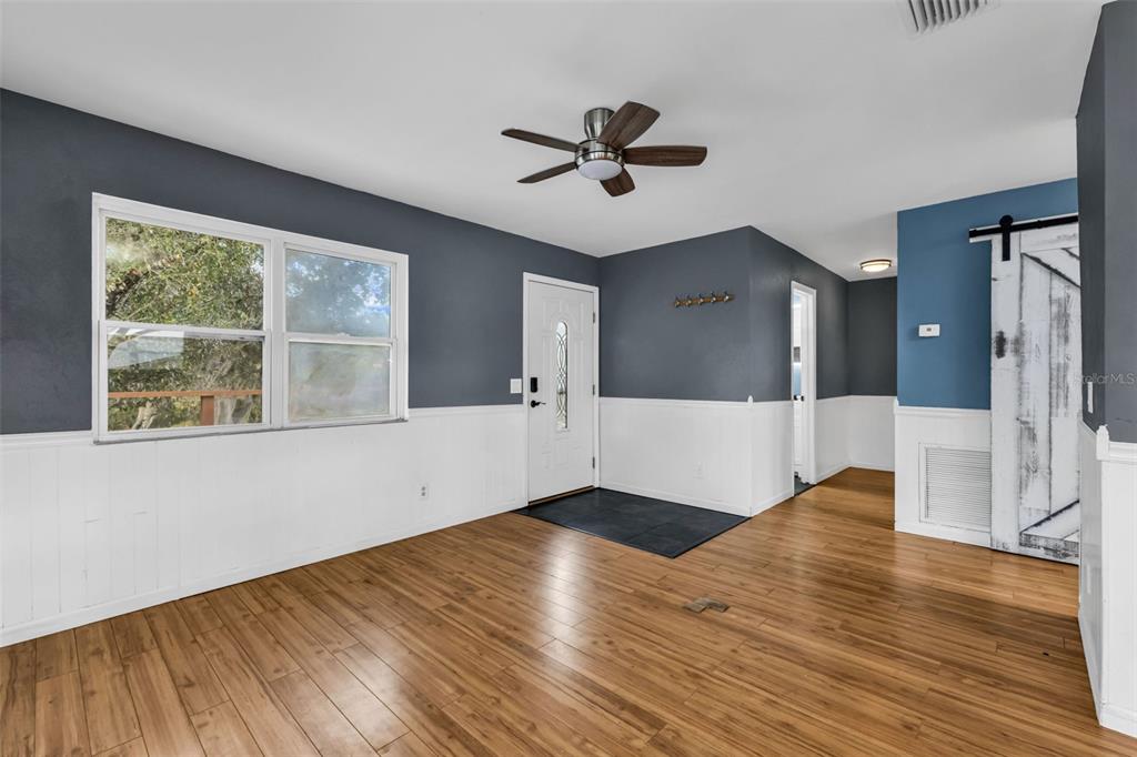 29341 Passion Flower Street Punta Gorda, FL 33982 - Photo 11 of 68 a view of empty room with wooden floor and fan