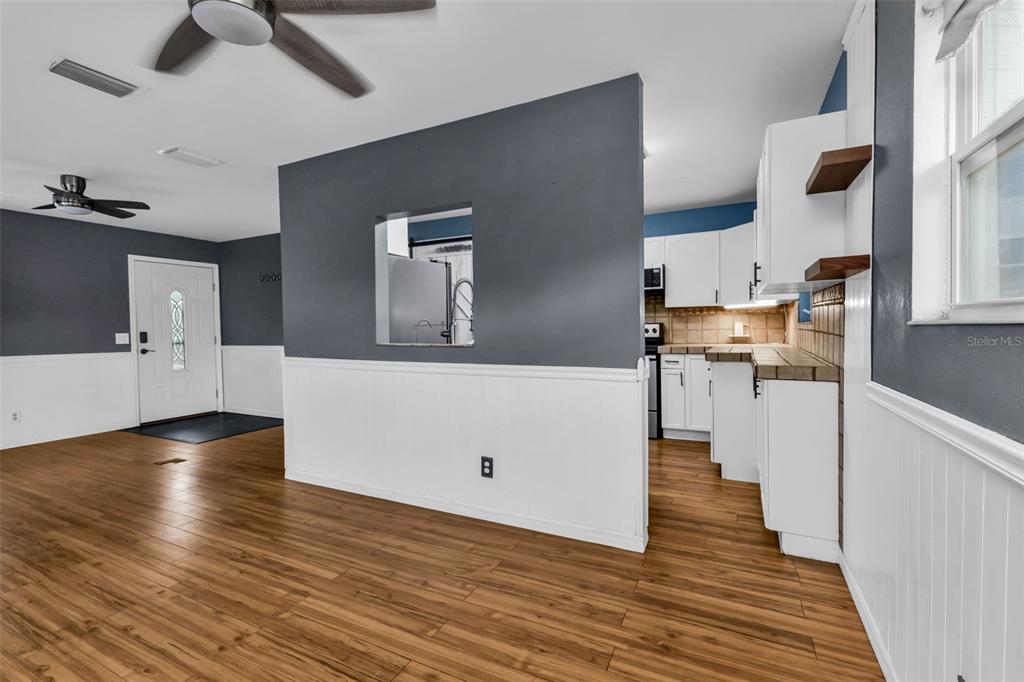 29341 Passion Flower Street Punta Gorda, FL 33982 - Photo 15 of 68 a view of a kitchen with wooden floor and a ceiling fan