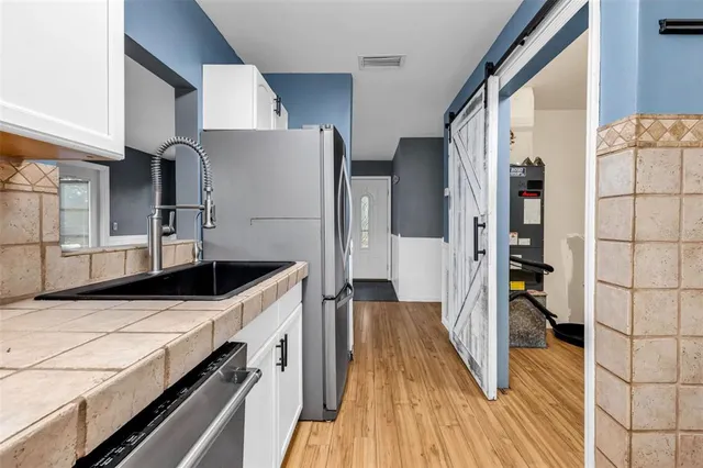 a view of a kitchen cabinets and wooden floor