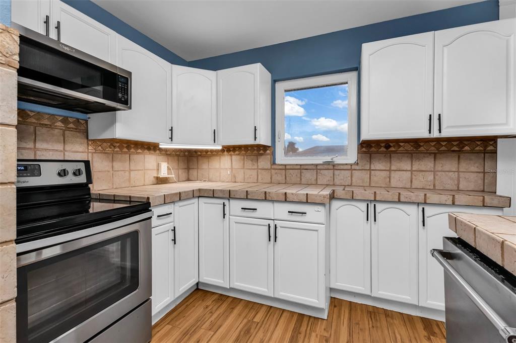 29341 Passion Flower Street Punta Gorda, FL 33982 - Photo 21 of 68 a kitchen with a sink stove and cabinets