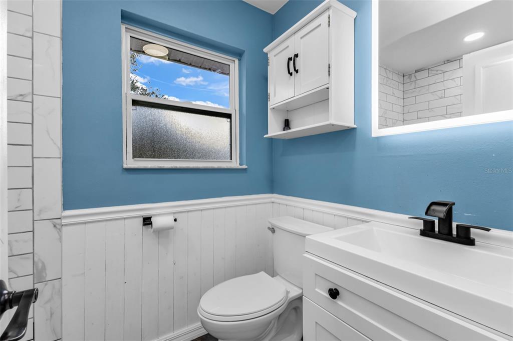 29341 Passion Flower Street Punta Gorda, FL 33982 - Photo 25 of 68 a bathroom with a toilet a sink and mirror