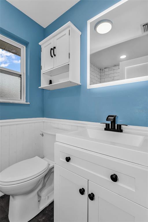 29341 Passion Flower Street Punta Gorda, FL 33982 - Photo 26 of 68 a bathroom with a sink a mirror and toilet