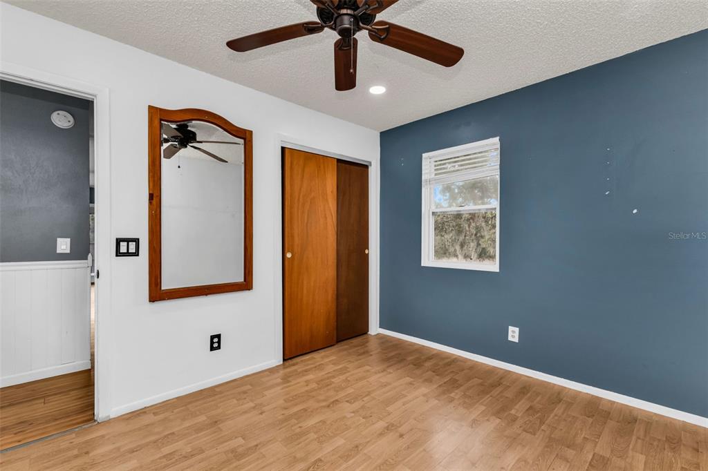 29341 Passion Flower Street Punta Gorda, FL 33982 - Photo 29 of 68 a view of an empty room with window and wooden floor