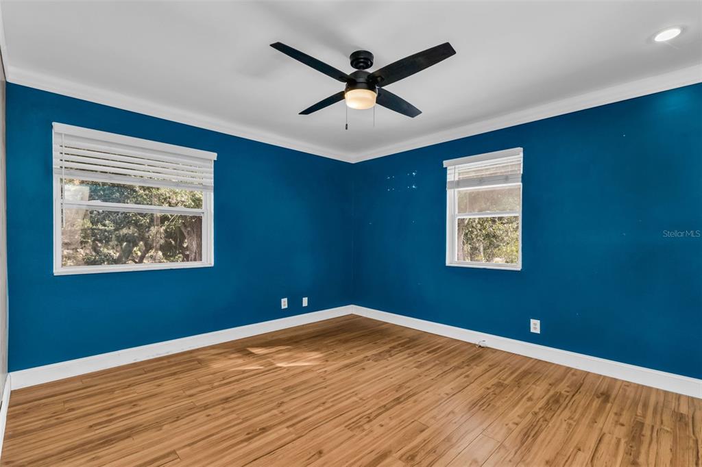 29341 Passion Flower Street Punta Gorda, FL 33982 - Photo 31 of 68 a view of an empty room with wooden floor and a ceiling fan