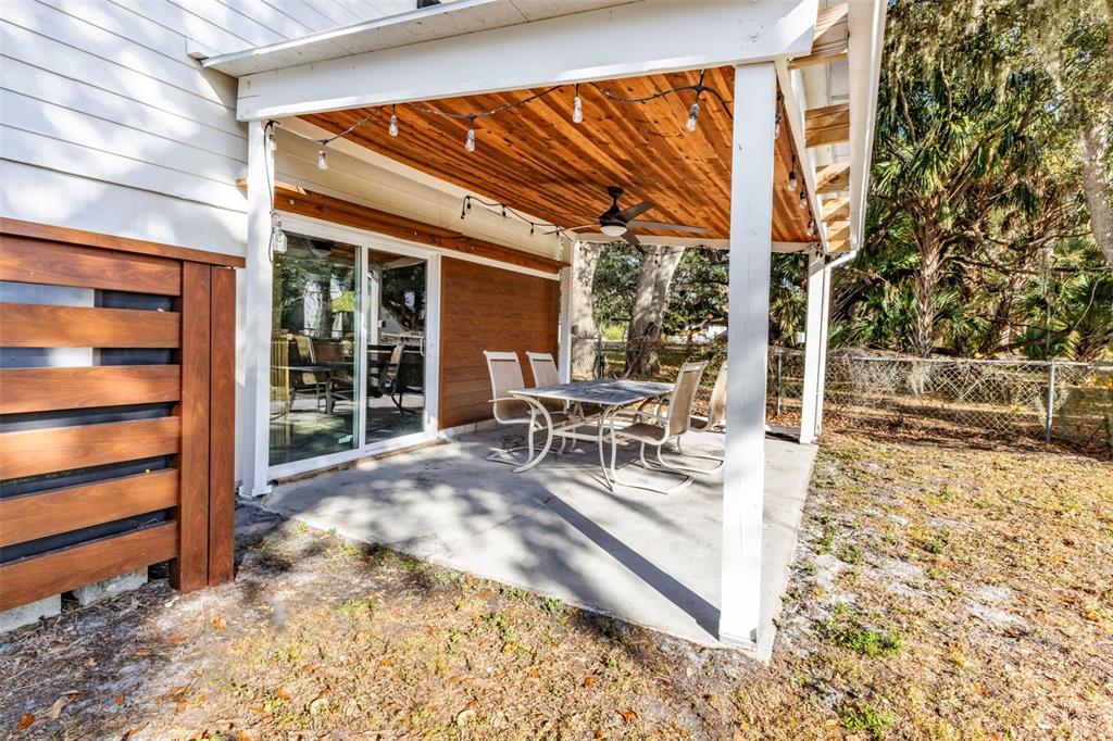 29341 Passion Flower Street Punta Gorda, FL 33982 - Photo 35 of 68 a view of a patio with table and chairs and floor to ceiling window
