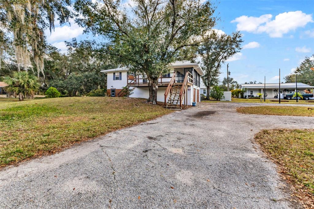 29341 Passion Flower Street Punta Gorda, FL 33982 - Photo 49 of 68 a front view of a house with a yard and trees