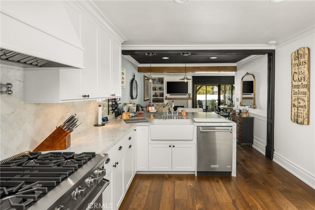 1055 Tustin Pines Way Tustin, CA 92780 - Photo 16 of 31 a kitchen with a sink and wooden floor
