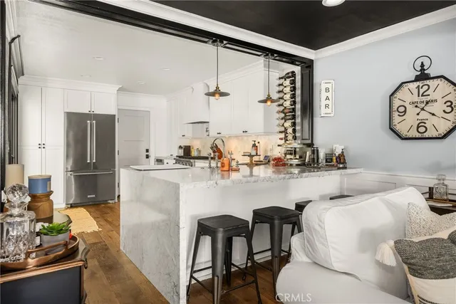 a kitchen with stainless steel appliances granite countertop a sink and a refrigerator