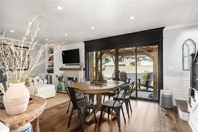 a dining room with furniture a flat screen tv and a large window