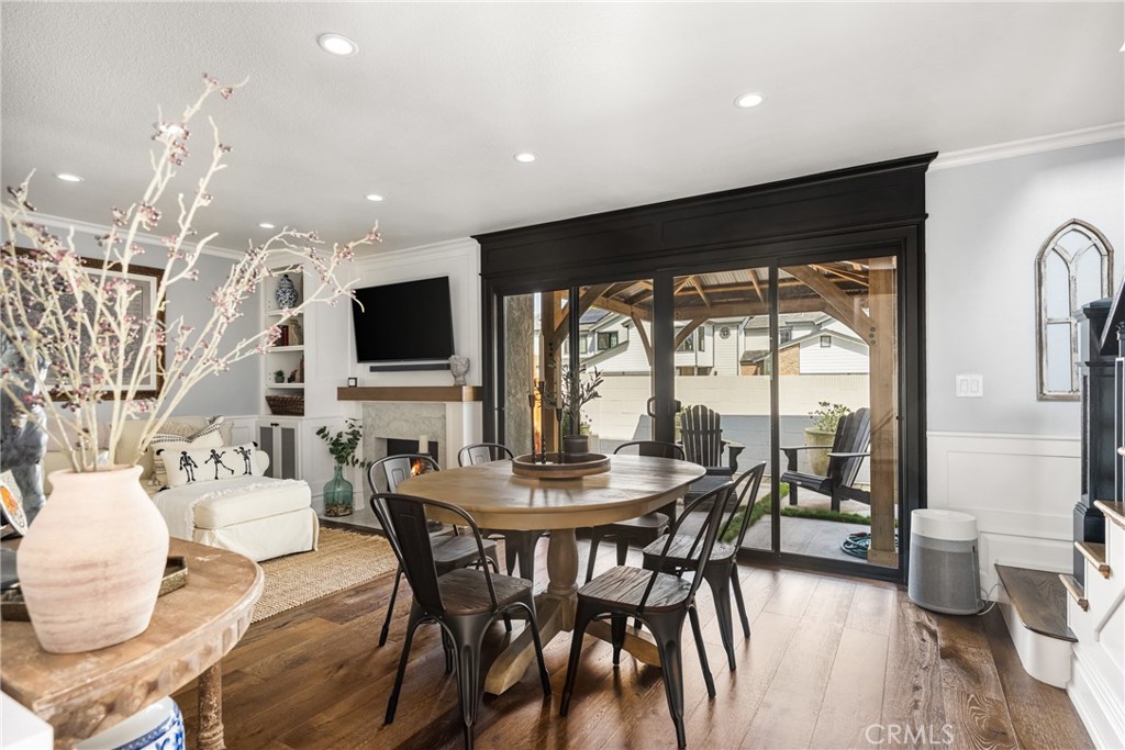 1055 Tustin Pines Way Tustin, CA 92780 - Photo 6 of 31 a dining room with furniture a flat screen tv and a large window