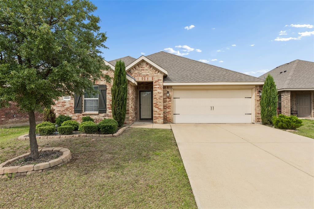 2850 Dusty Road Forney, TX 75126 - Photo 1 of 11 Brick facade home featuring a two-car garage, mature landscaping, and a concrete driveway