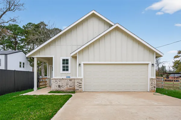 a view of a house with a yard and garage
