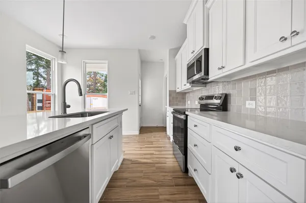 a kitchen with stainless steel appliances granite countertop a stove and a sink