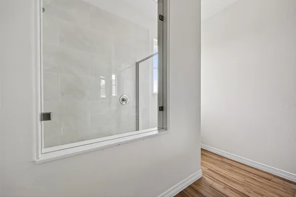 a bathroom with a granite countertop sink a toilet and a mirror