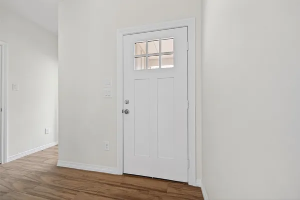 an empty room with wooden floor and closet
