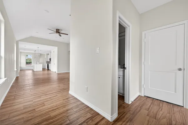 a view of a hallway with wooden floor