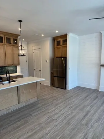 a view of a kitchen with a sink and a refrigerator