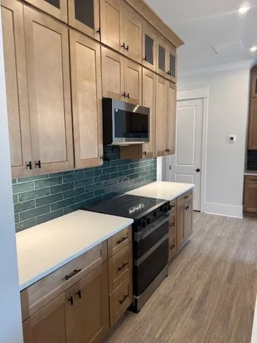 a kitchen with stainless steel appliances a stove and a sink