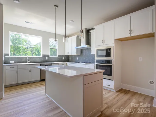 a kitchen with a sink window and cabinets