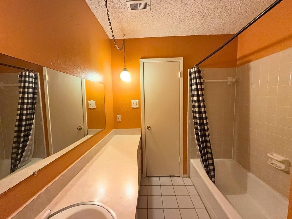 1613 Edgehill Road Benbrook, TX 76126 - Photo 12 of 22 a bathroom with a bathtub and shower
