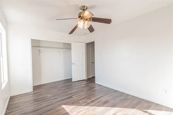 a view of a room with wooden floor