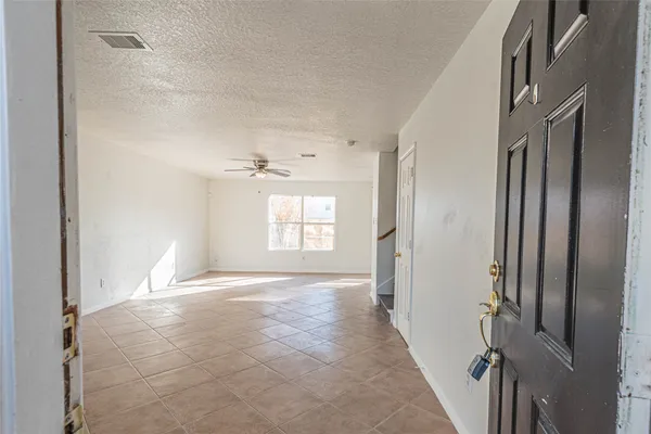a view of an empty room and a window