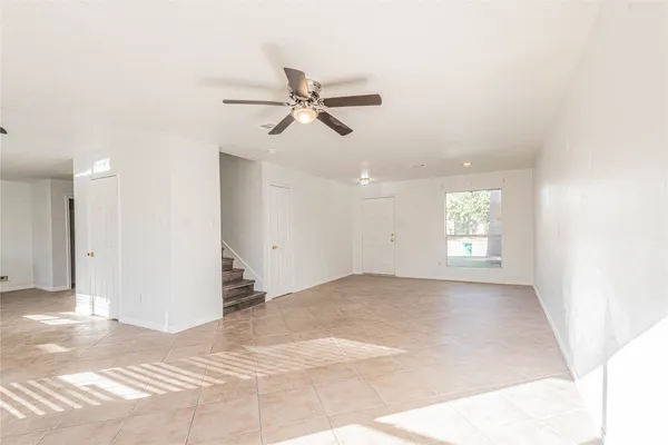 a view of a livingroom with a ceiling fan and window