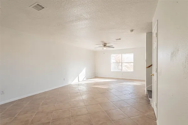 a view of an empty room and a window