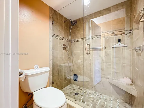 a white toilet sitting next to a bathroom sink