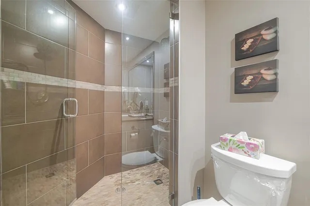 an aerial view of a house with a yard and lake view