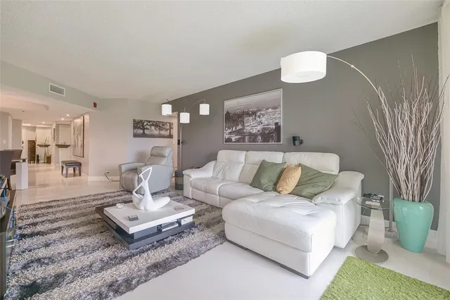a kitchen with stainless steel appliances granite countertop a refrigerator and white cabinets