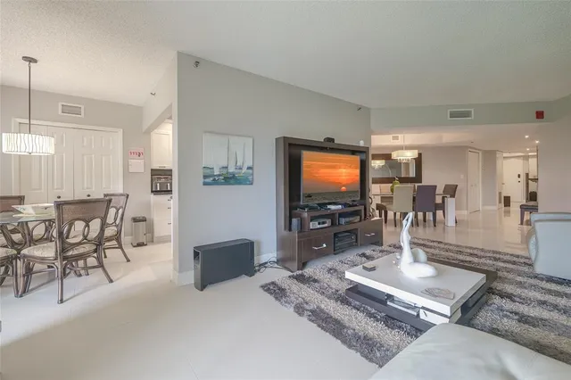 a kitchen with granite countertop white cabinets and stainless steel appliances