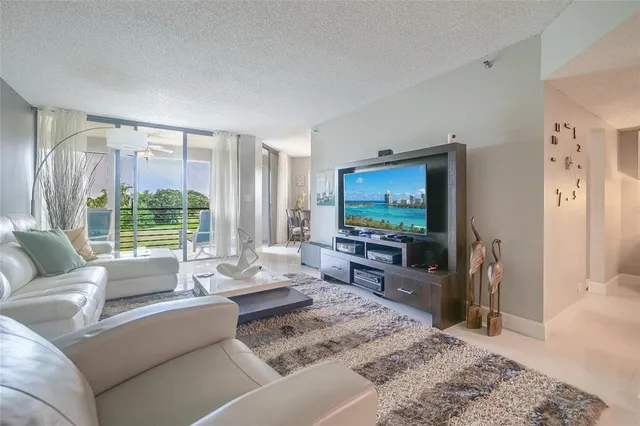 a view of a hallway with workspace and a window