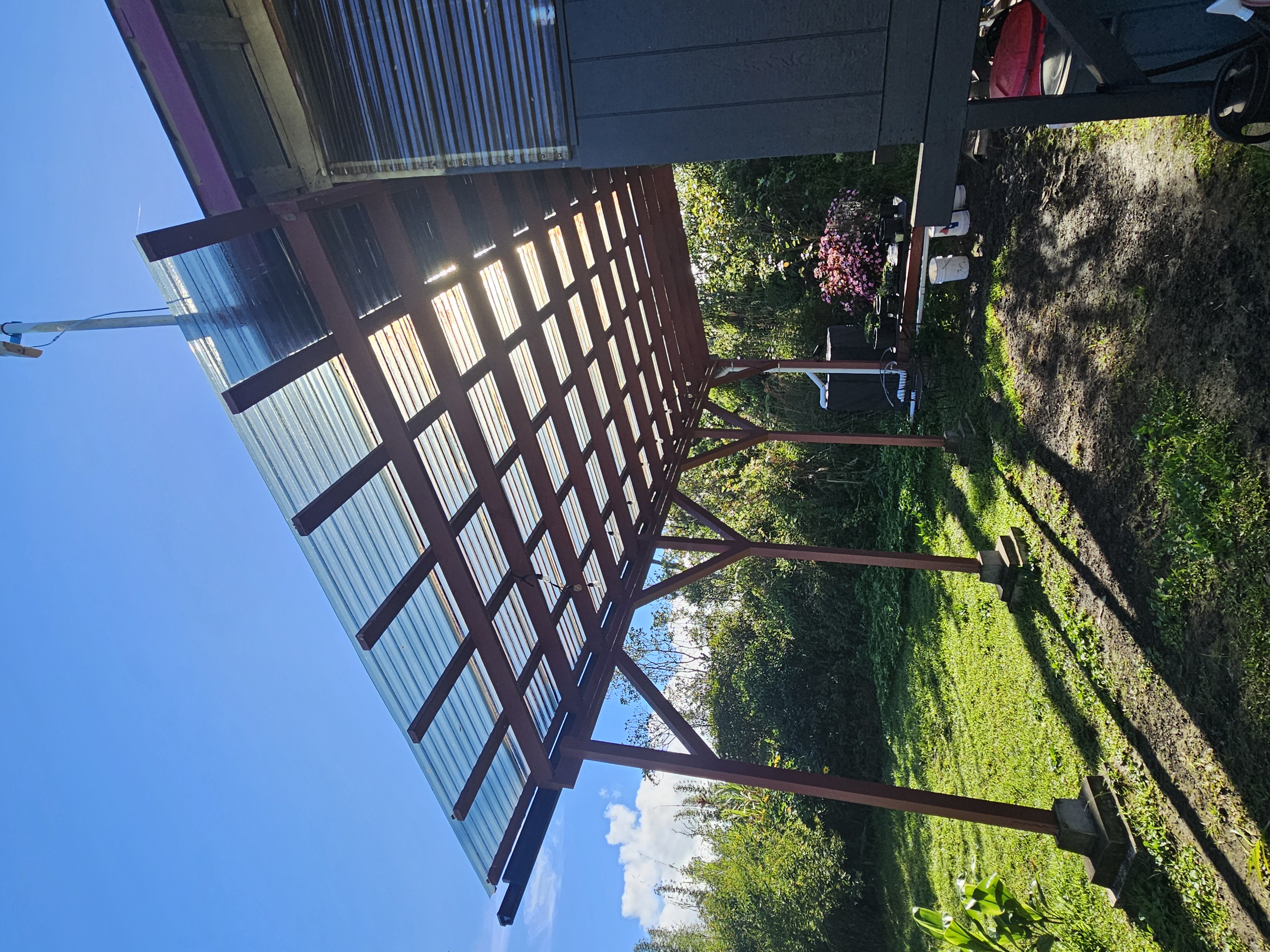 11-2093 Alii Wao Road Pahoa, HI 96778 - Photo 6 of 21 a view of a backyard with table and chairs under an umbrella with a small yard