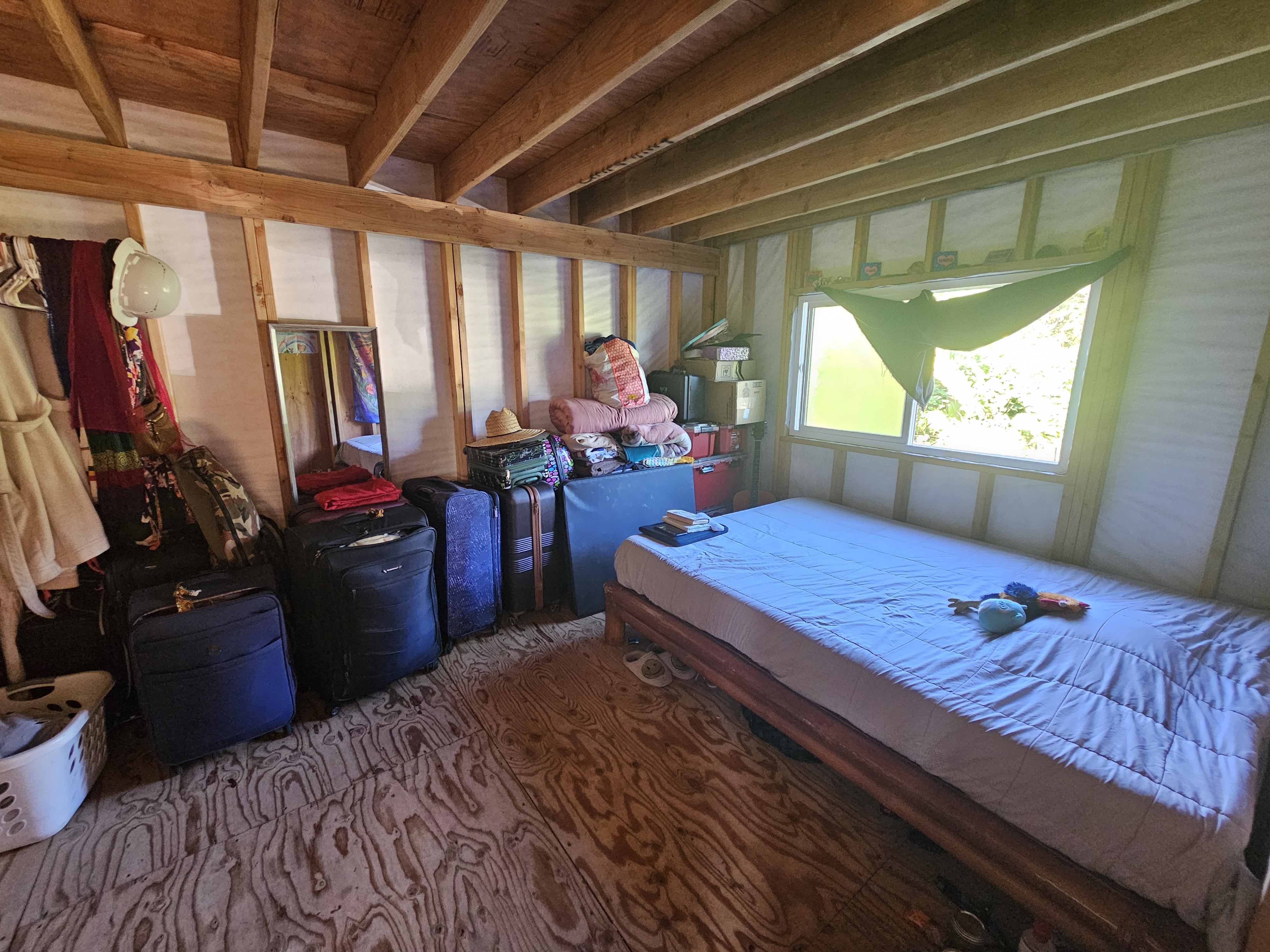 11-2093 Alii Wao Road Pahoa, HI 96778 - Photo 9 of 21 a bed room with a bed window and potted plant