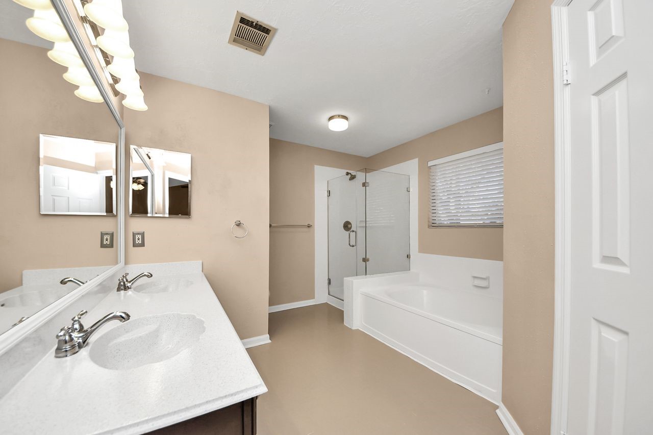 7607 Plum Tree Forest Circle Houston, TX 77095 - Photo 24 of 42 a bathroom with a tub sink and mirror