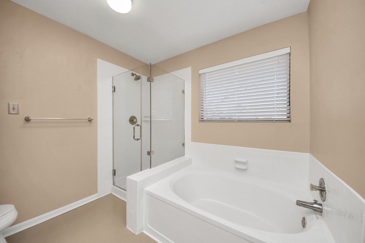 7607 Plum Tree Forest Circle Houston, TX 77095 - Photo 27 of 42 a white bath tub sitting next to a small bathroom