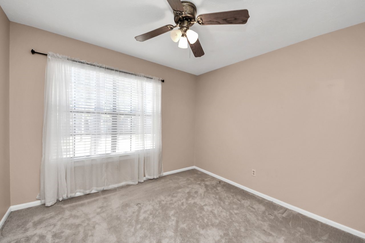 7607 Plum Tree Forest Circle Houston, TX 77095 - Photo 30 of 42 an empty room with windows and fan