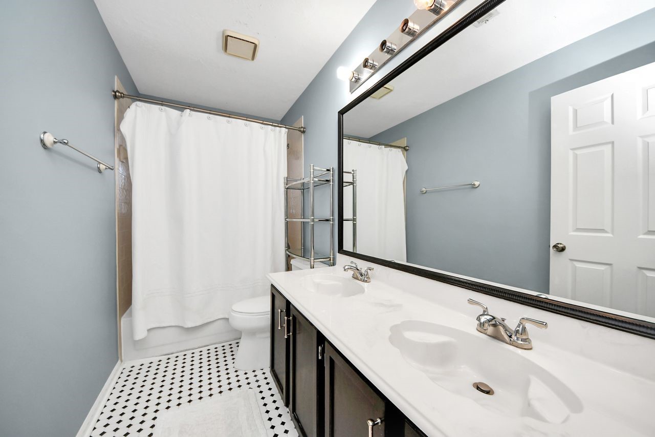7607 Plum Tree Forest Circle Houston, TX 77095 - Photo 35 of 42 a bathroom with a sink a mirror and a shower