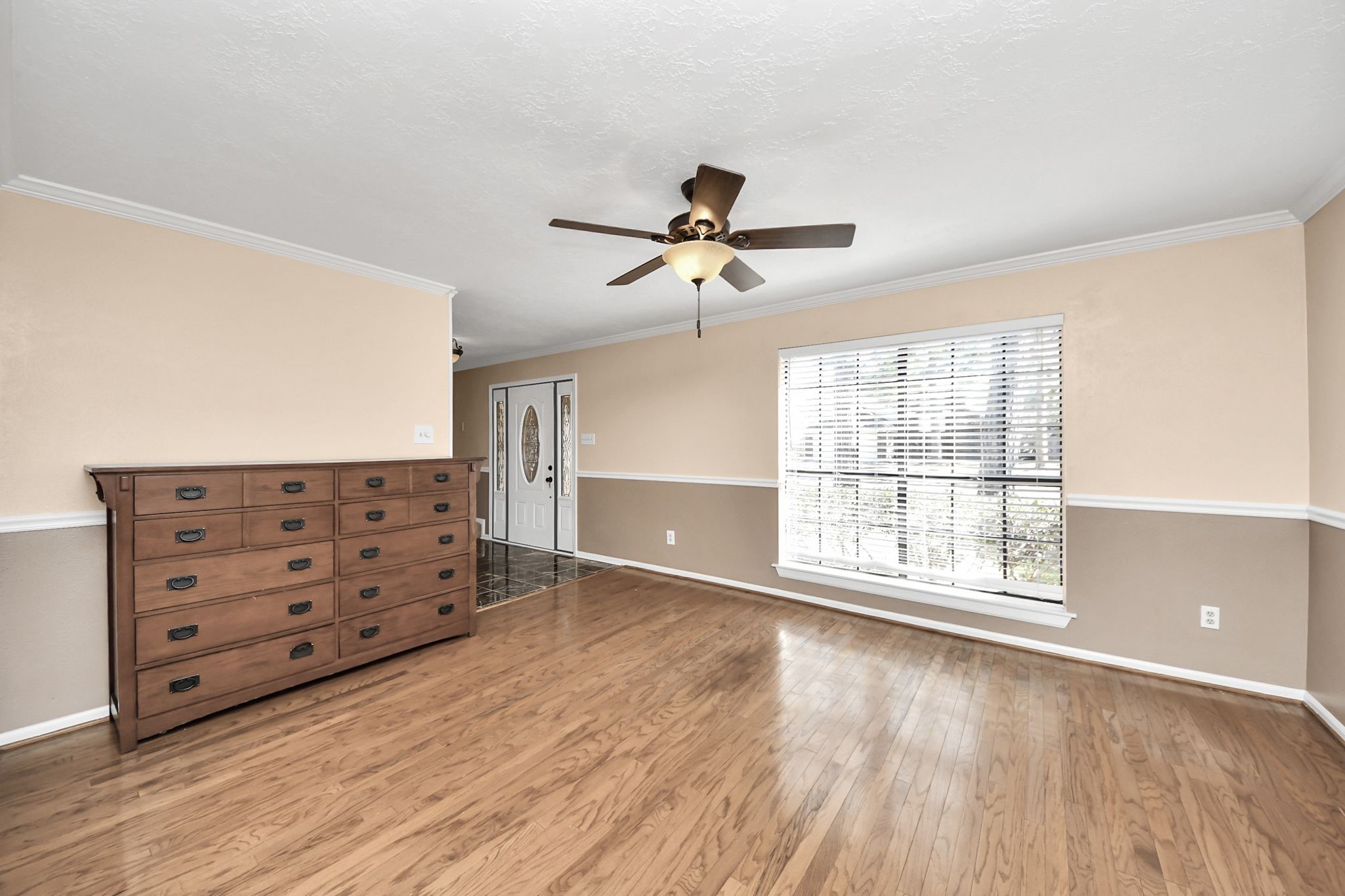 7607 Plum Tree Forest Circle Houston, TX 77095 - Photo 10 of 42 a view of an empty room with a window and wooden floor