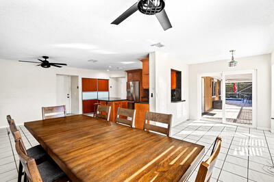 10056 Country Brook Road Boca Raton, FL 33428 - Photo 13 of 15 a dining hall with a dining table and chairs with wooden floor