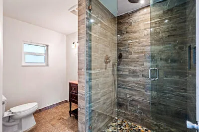 a bathroom with a toilet and a shower