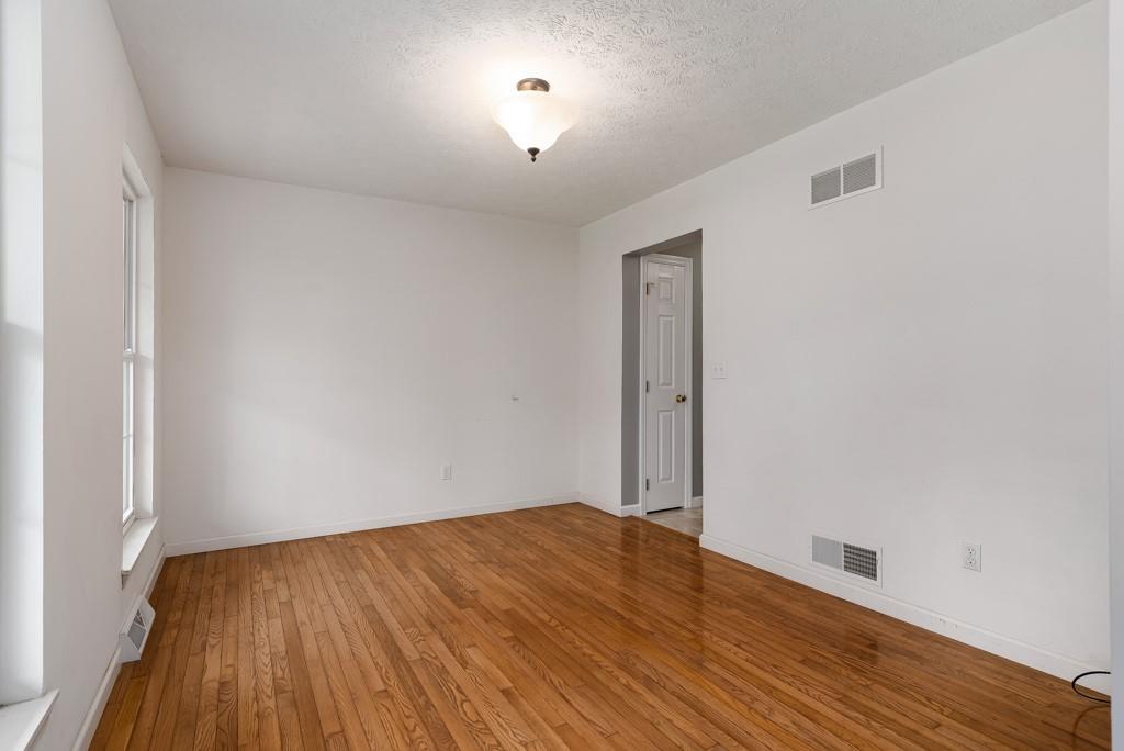 2389 Jenkinson Drive Pittsburgh, PA 15237 - Photo 7 of 29 an empty room with wooden floor and windows