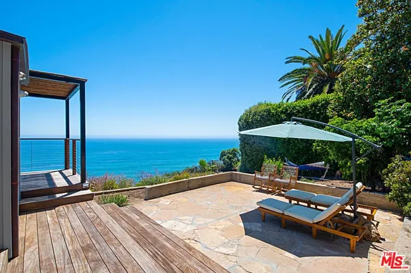 a patio with water view fountain and wooden floor