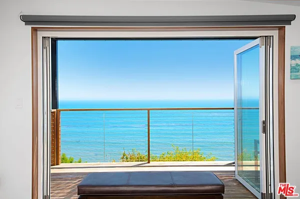 a kitchen with cabinets appliances a sink and a window