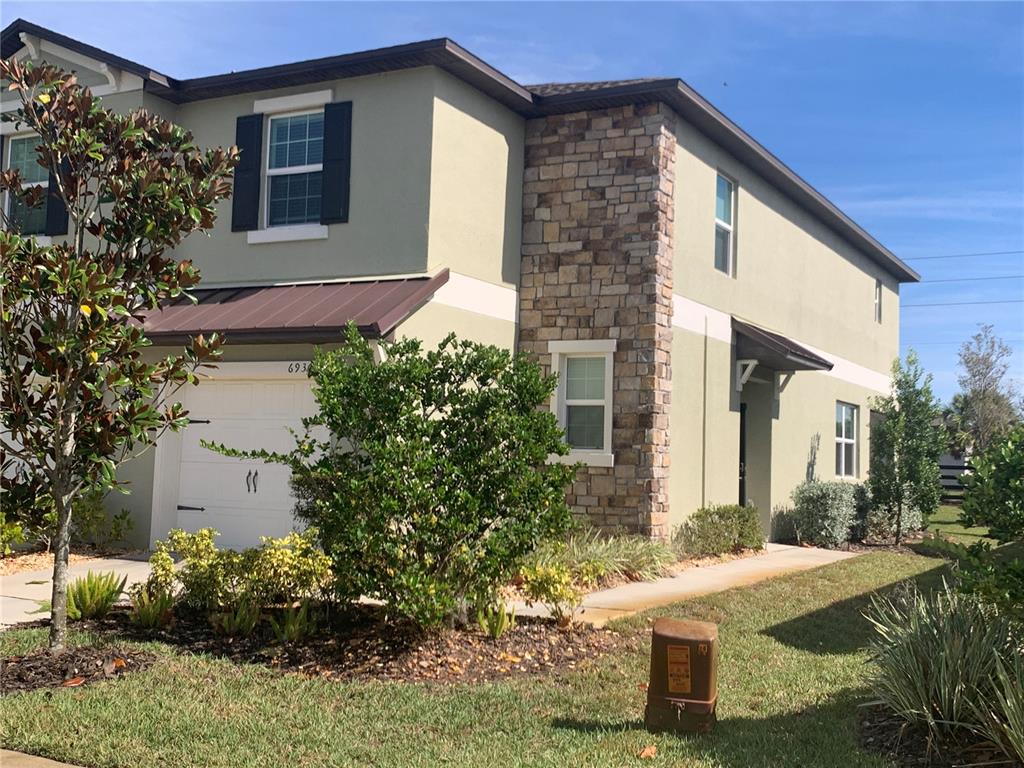 6930 Ripple Pond Loop Zephyrhills, FL 33541 - Photo 2 of 29 a front view of a house with garden